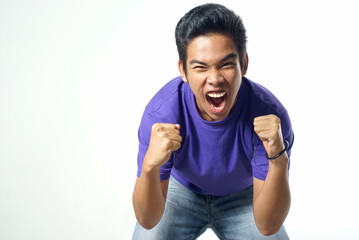 Asian man shouting with clenched fists