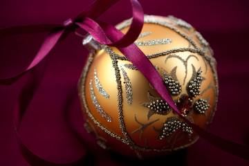 Christmas ball with purple satin ribbon