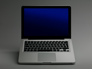 Laptop on gray fond