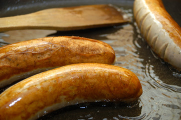 some grilled organic sausages in a pan