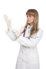 attractive female doctor putting on surgical glove