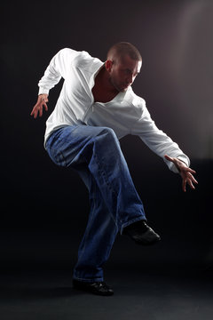 Hip hop man dancer against black background