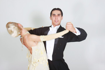 young couple dancing over white