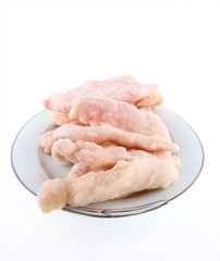 Frozen chicken thighs on platter end view
