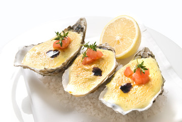 oysters with sauce and lemon on plate
