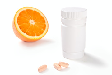oranges, vitamin pills and container isolated