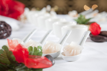 dumplings served on white spoons