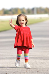 Little girl  in the autumn park