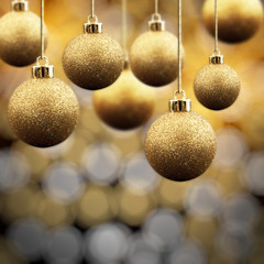 Gold Christmas balls on a multi coloured sparkling background