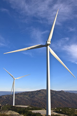 windmills in the top of a montain with blue sky and clouds, alte