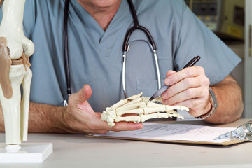 doctor studying a hand joint