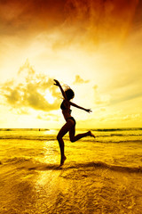 The jumping girl on a tropical beach