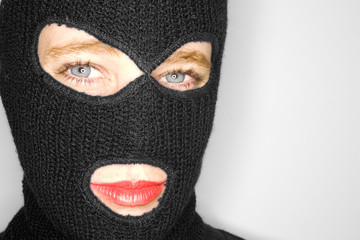 A stock photograph of an attractive woman wearing a balaclava.