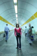 Subway - young woman standing in a subway corridor while the cro