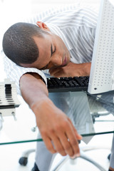Tired businessman sleeping on his desk