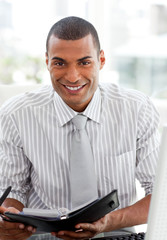 Fototapeta premium Smiling businessman consulting his agenda
