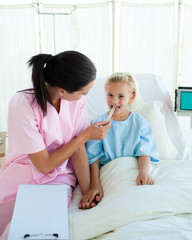 Fototapeta premium Young nurse attending a child patient