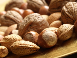 Closeup of mixed nuts: hazelnuts, walnuts, almonds.