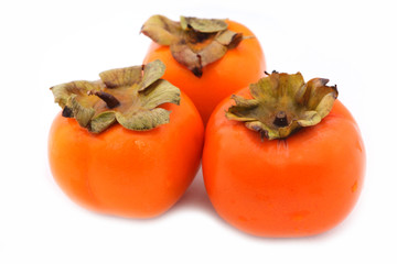 Tree ripe persimmons isolated on white background