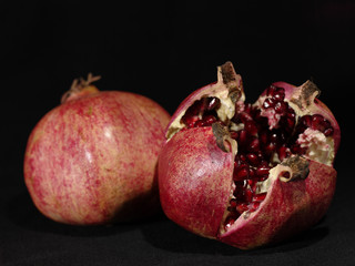 pomegranate fruit on the black background. is not isolated