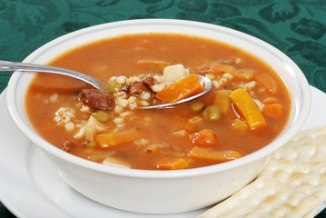 closeup beef barley soup with a spoonful