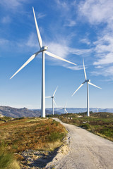 windmills in the top of a montain with blue sky and clouds, alte