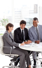 Young business people sitting at a conference table