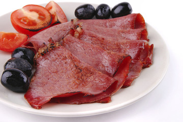 sliced served sausage with raw tomato