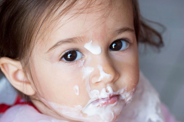 Baby eating cream