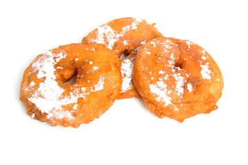Three home baked Dutch apple fritters over white background