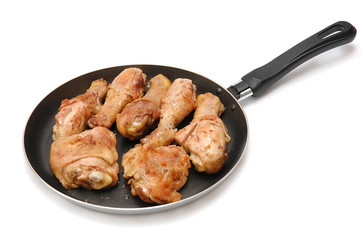 Roast chicken on a frying pan on a white background