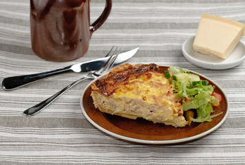 Pie dinner with cheese and ham and some salad