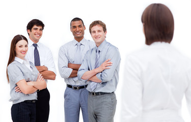 Brunette businesswoman looking back at her colleagues