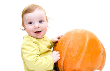 Baby boy playing with pumpkin