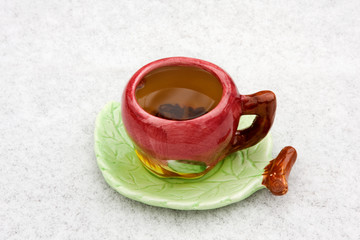 A cup of tea on a snowy background