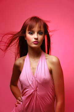 Fashion model Posed on light background in dress.