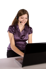 Happy woman with laptop and headset