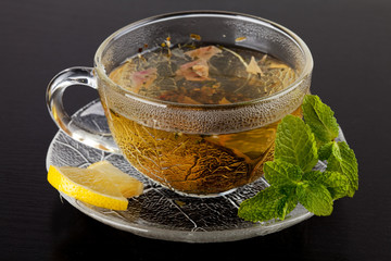 Cup of green tea with lemon and mint