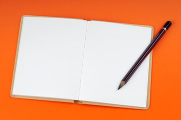 Blank open book with white page on orange background