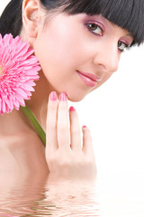 Young woman with gerber flower