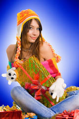 Beautiful smiling woman in hat with gift in box