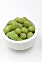 some organic and fresh pea in a white bowl