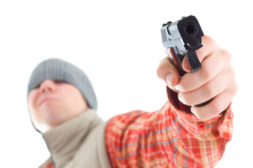 Young man is aiming with gun