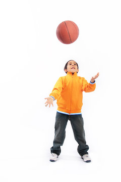 Boy throwing basketball up in the air