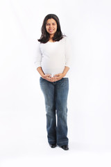 Young hispanic pregnant woman standing isolated