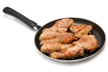 Roast chicken on a frying pan on a white background