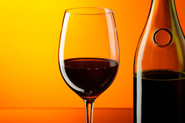 Glass and bottle of red wine.