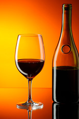 Glass and bottle of red wine.
