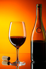 Glass and bottle of red wine.