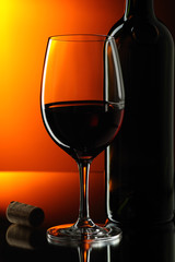 Glass and bottle of red wine.
